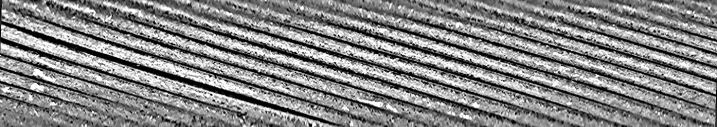 The unwrapped detail image: grey strands as parallel diagonal bands with dark grooves between them; at the left one groove is wider and darker than the rest.